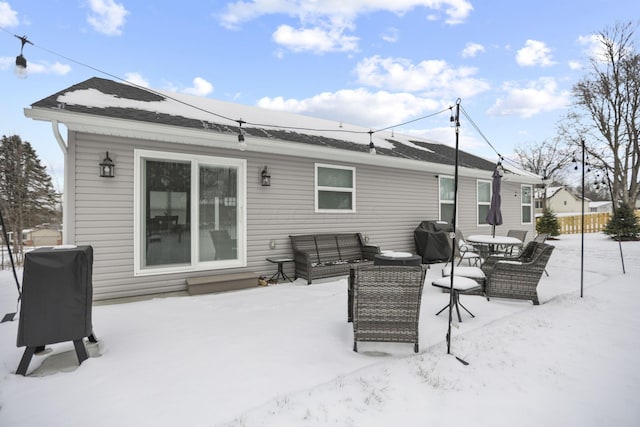 view of snow covered rear of property