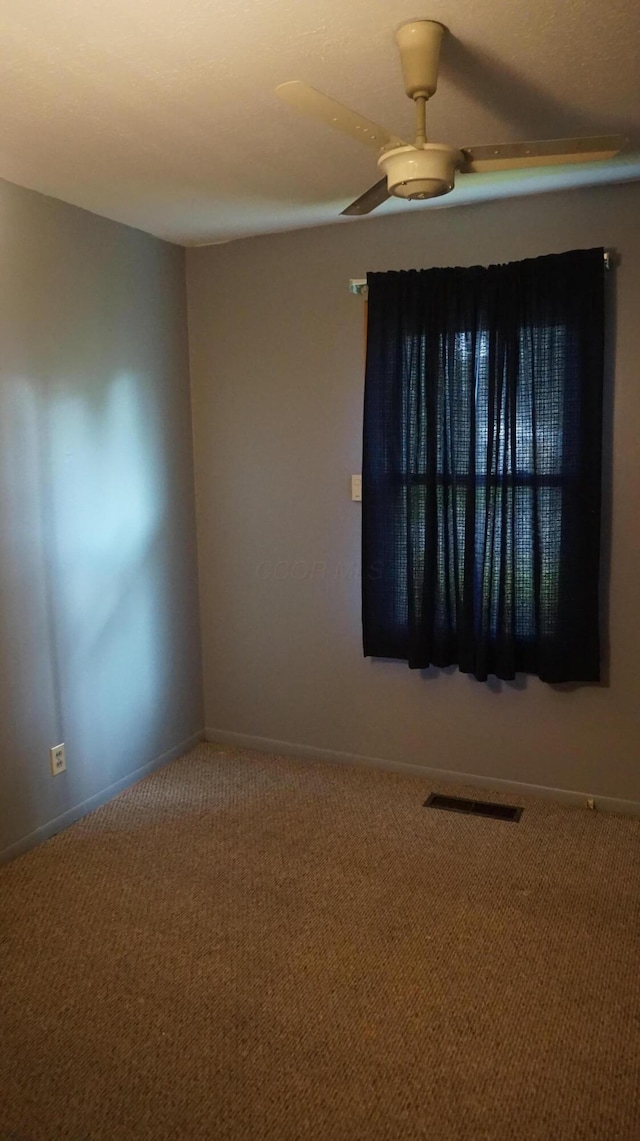 empty room with ceiling fan and carpet flooring