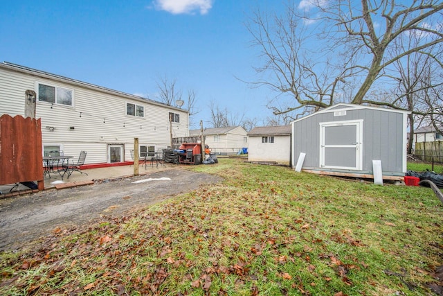 view of yard with a patio area and a storage unit