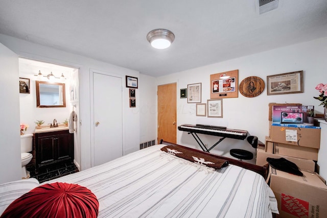 bedroom with sink and ensuite bathroom