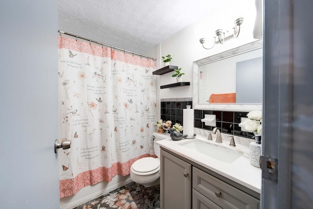 full bathroom with shower / tub combo with curtain, tile walls, vanity, a textured ceiling, and toilet