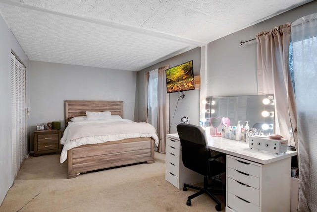 carpeted bedroom featuring a textured ceiling