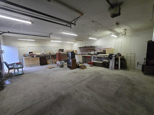 garage featuring a garage door opener and a workshop area