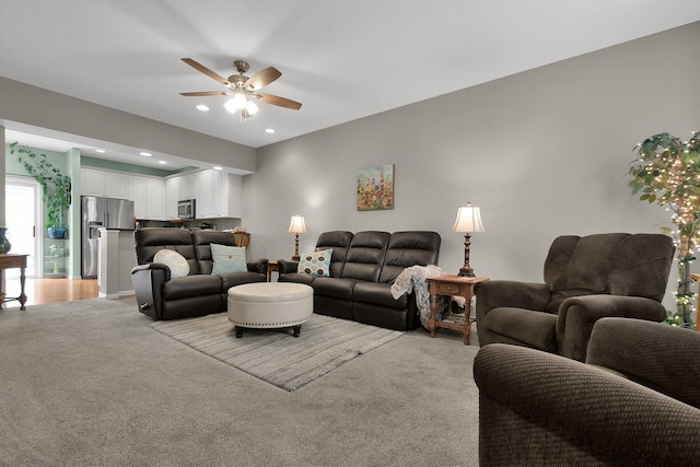 living room featuring light colored carpet and ceiling fan