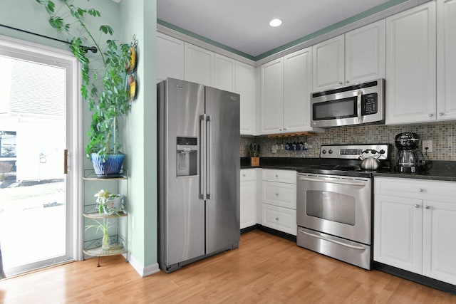 kitchen with appliances with stainless steel finishes and white cabinets