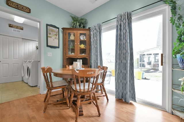 dining space featuring light hardwood / wood-style floors and independent washer and dryer