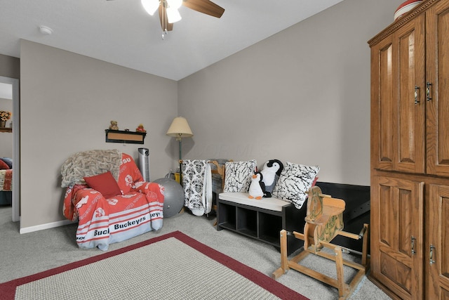 living area featuring ceiling fan and carpet