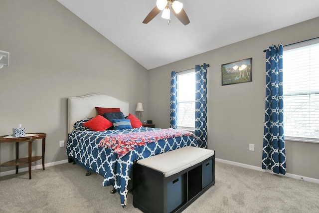 bedroom with light colored carpet, lofted ceiling, and multiple windows