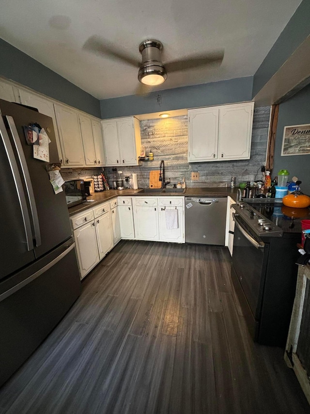 kitchen with sink, appliances with stainless steel finishes, backsplash, dark hardwood / wood-style floors, and white cabinets