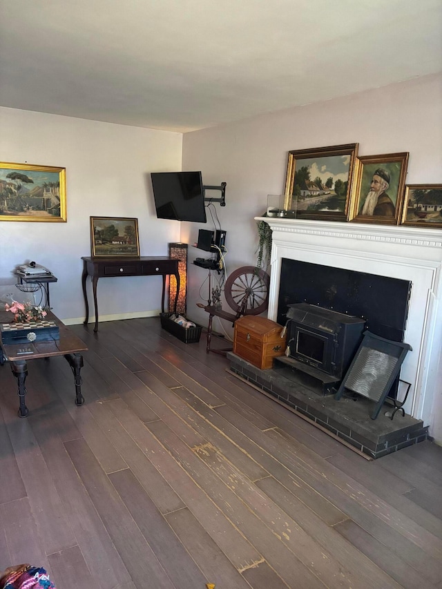 living room featuring dark wood-type flooring and a wood stove