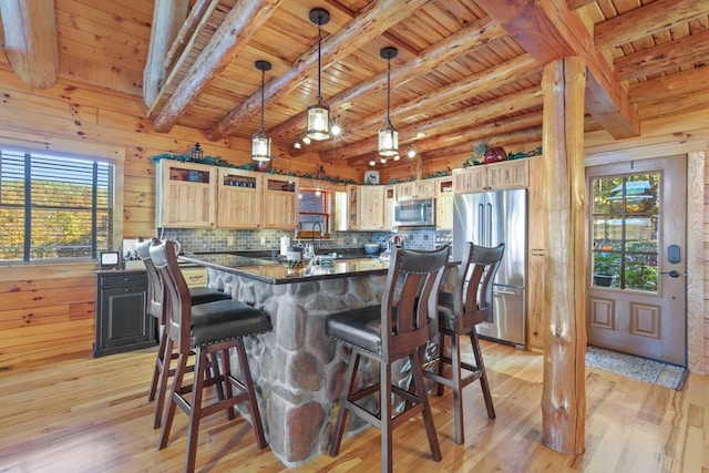 kitchen with appliances with stainless steel finishes, light brown cabinets, wooden ceiling, and decorative light fixtures