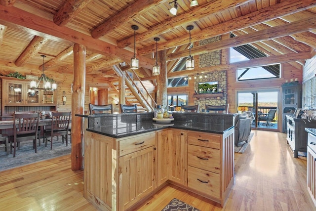 kitchen featuring light hardwood / wood-style flooring, wood ceiling, and decorative light fixtures