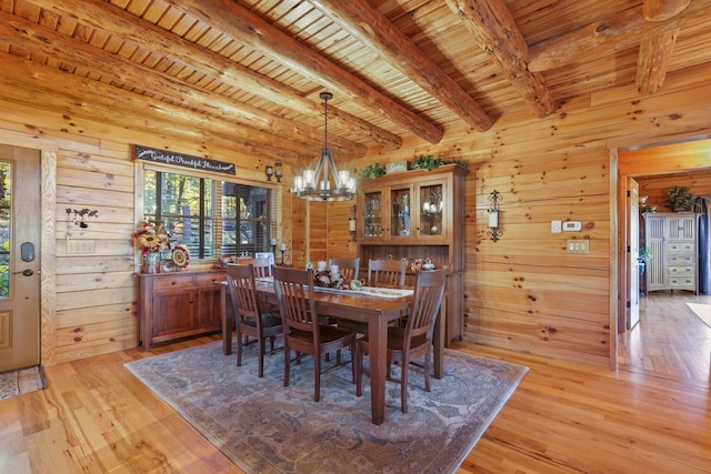 dining room featuring wood ceiling, an inviting chandelier, beam ceiling, and light hardwood / wood-style floors