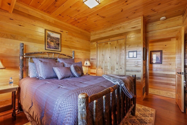 bedroom featuring wood ceiling, hardwood / wood-style floors, and wood walls