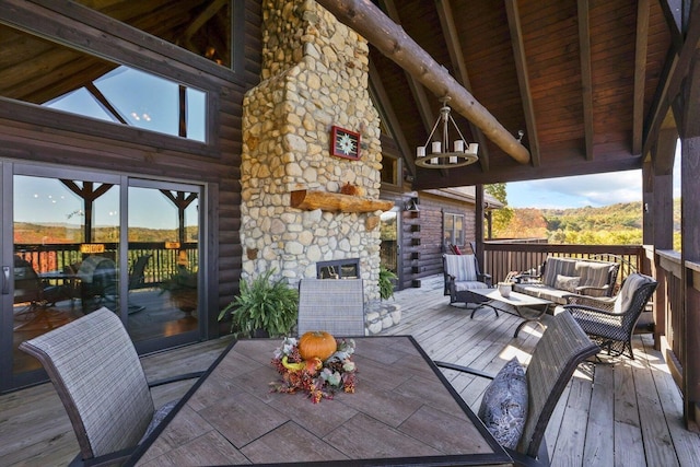 wooden deck featuring an outdoor living space with a fireplace