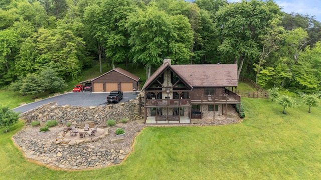 20358 Buena Vista Rd, Rockbridge, OH 43149 - back of property featuring an outdoor structure, a garage, a yard, a deck, and a chimney