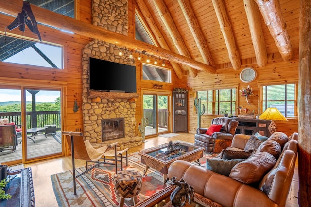 20358 Buena Vista Rd, Rockbridge, OH 43149 - living area featuring high vaulted ceiling, hardwood / wood-style flooring, wood walls, wood ceiling with exposed beams, and a fireplace