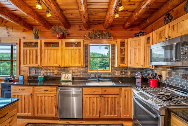 20358 Buena Vista Rd, Rockbridge, OH 43149 - kitchen with stainless steel appliances, a sink, track lighting, wood ceiling with exposed beams, and backsplash