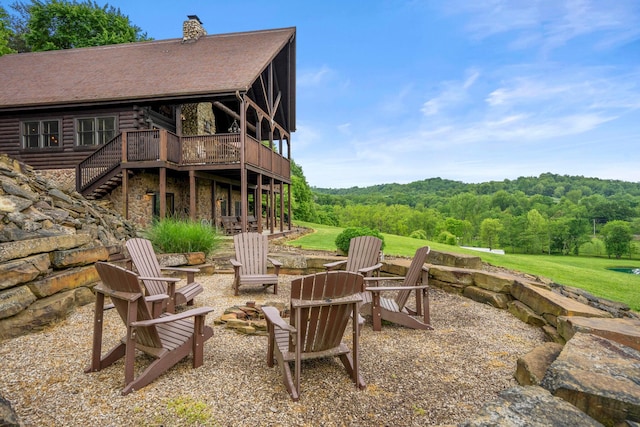 20358 Buena Vista Rd, Rockbridge, OH 43149 - view of patio / terrace with a fire pit, a deck, stairway, and a view of trees