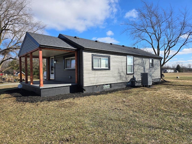 view of side of property featuring a lawn and central air condition unit