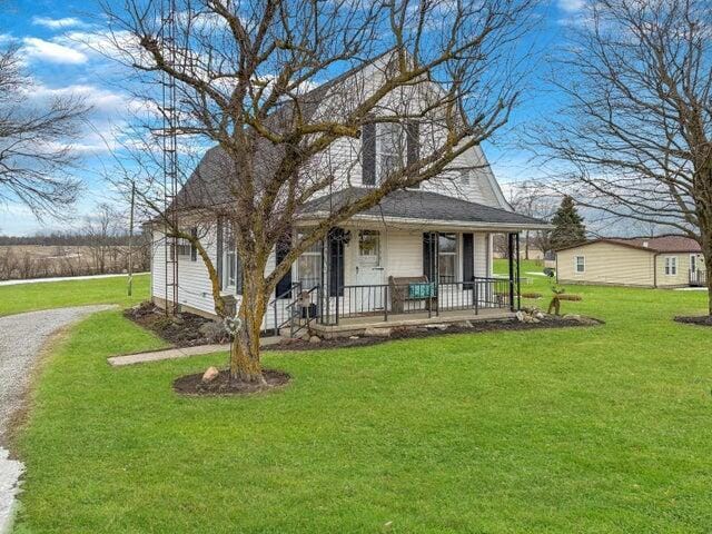 view of front of home with covered porch and a front yard