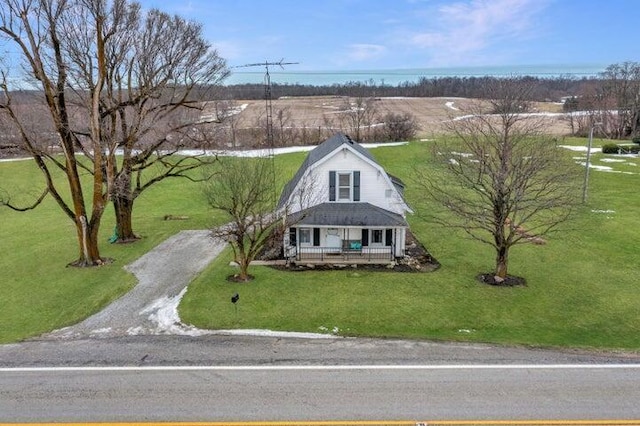 exterior space with covered porch and a front lawn