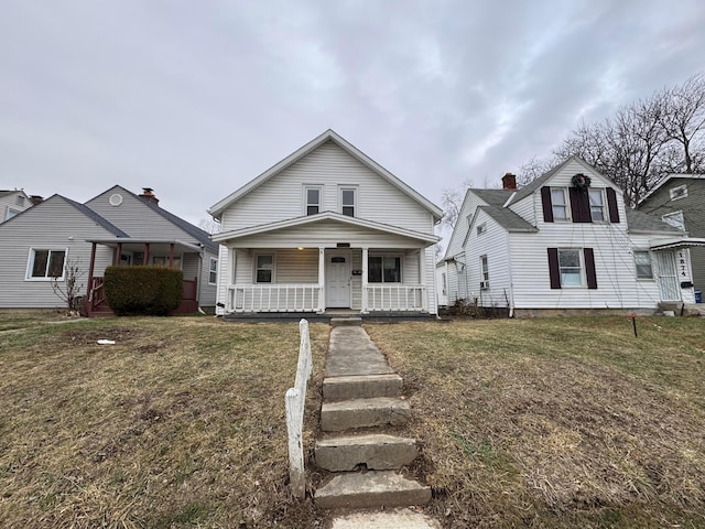 view of front of property with a porch and a front yard