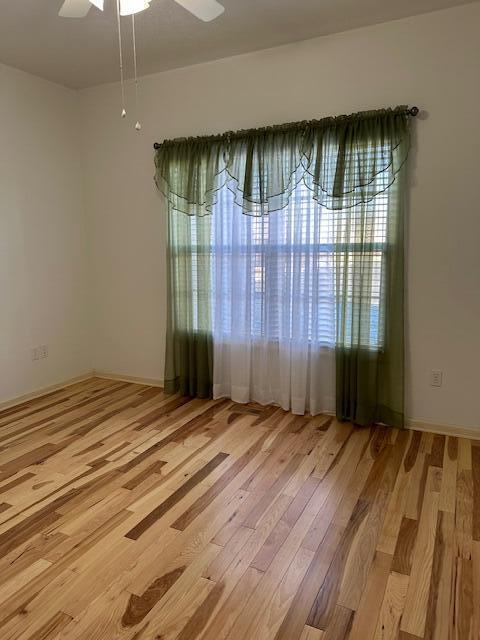 unfurnished room featuring ceiling fan and light hardwood / wood-style flooring