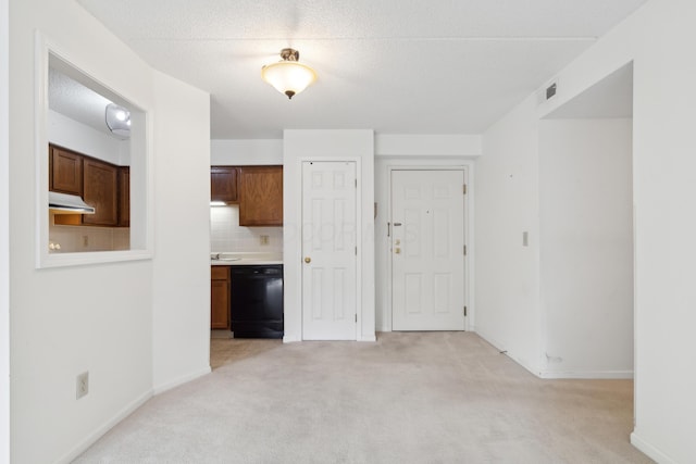 carpeted spare room with a textured ceiling