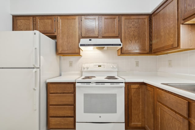 kitchen with backsplash and white appliances