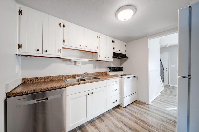 kitchen with sink, white appliances, white cabinets, and light wood-type flooring