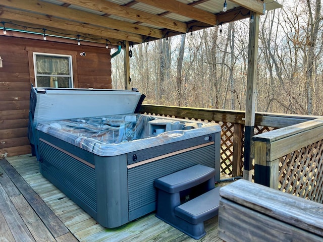 wooden deck with a hot tub