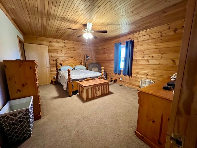 carpeted bedroom with ceiling fan, wooden walls, and wooden ceiling