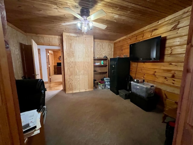 interior space with ceiling fan, wooden ceiling, and wooden walls