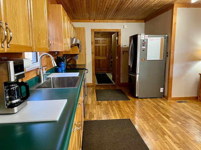 kitchen featuring stainless steel refrigerator, wooden ceiling, sink, and light wood-type flooring