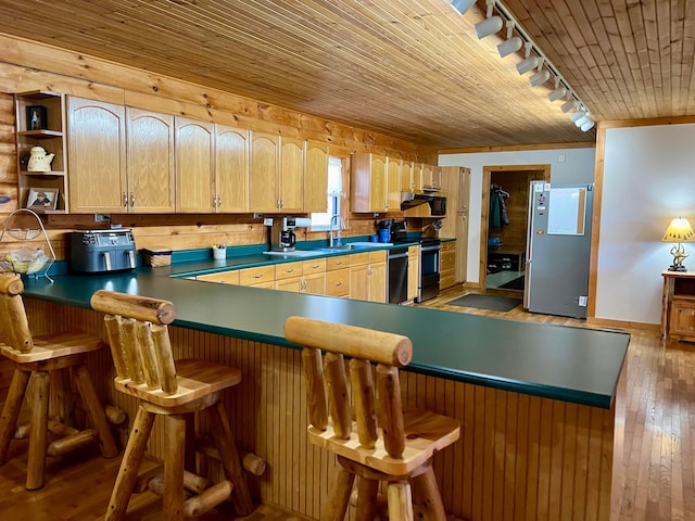 kitchen with a breakfast bar, sink, stainless steel appliances, wooden ceiling, and light wood-type flooring