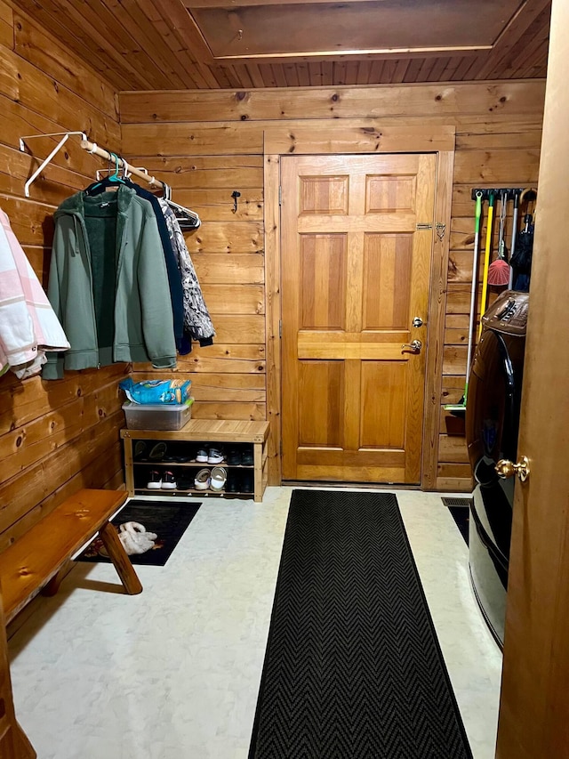 mudroom with wood walls