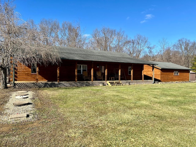 rear view of house featuring a yard