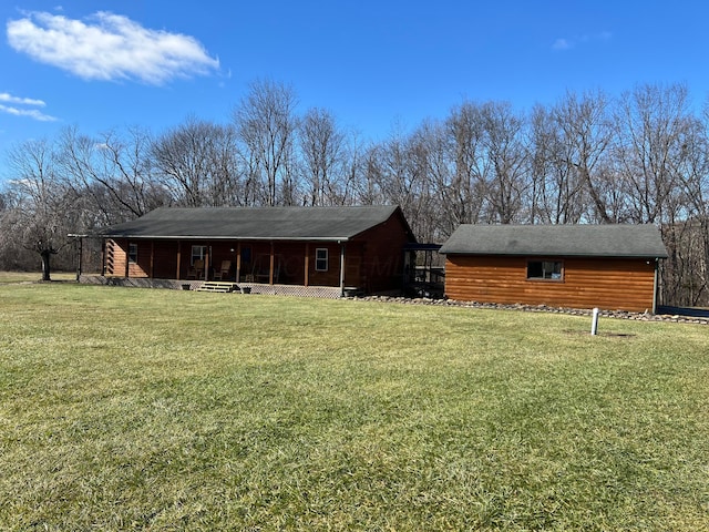 rear view of property with a yard