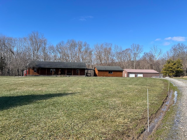 view of front of home featuring an outbuilding, a garage, and a front yard