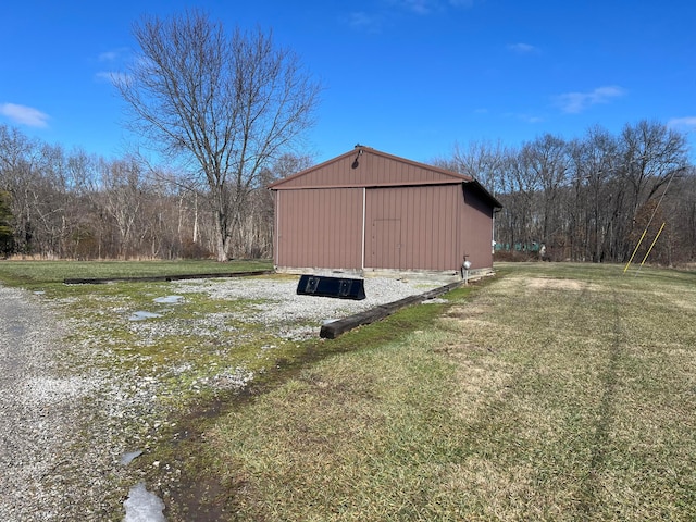 view of outbuilding featuring a yard