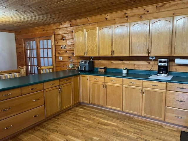 kitchen with wood ceiling, wooden walls, light hardwood / wood-style floors, and french doors