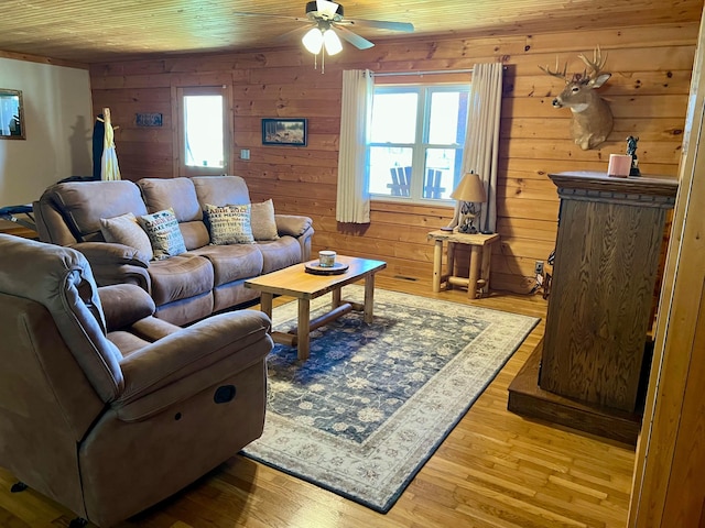 living room with wood ceiling, a wealth of natural light, ceiling fan, and light wood-type flooring