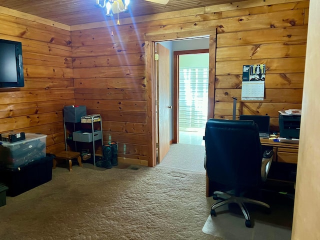 office area featuring carpet and wood walls