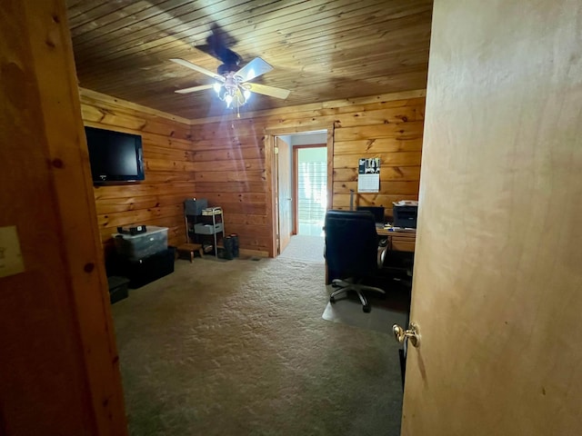 home office featuring wooden walls, wooden ceiling, ceiling fan, and carpet flooring