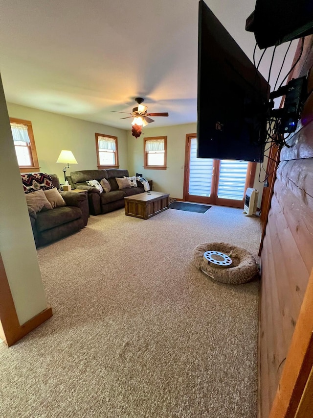 living room with ceiling fan and carpet flooring