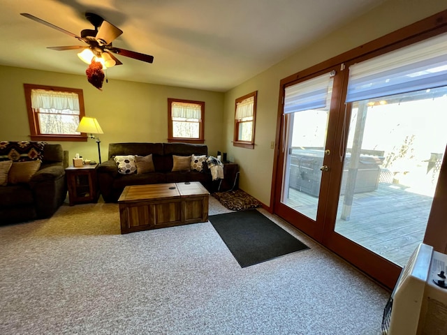 living room featuring light carpet, a wealth of natural light, and ceiling fan