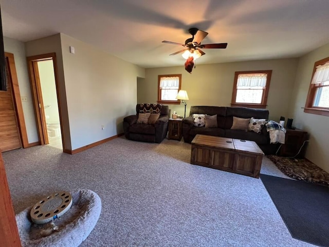 carpeted living room with ceiling fan