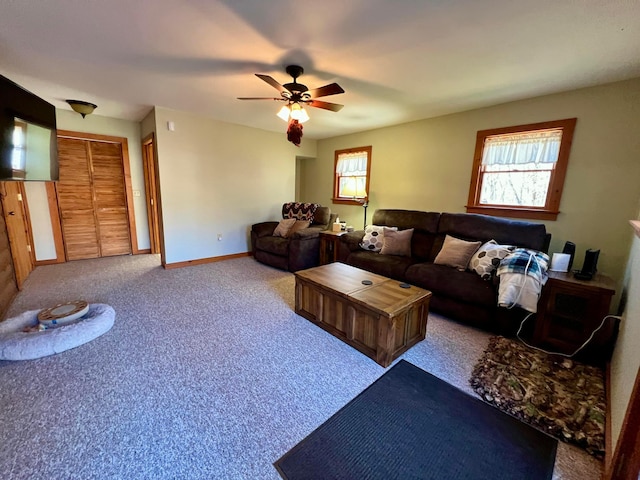 carpeted living room with ceiling fan