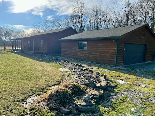 view of side of home with a garage and a lawn